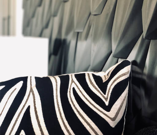 HUS - Our Spaces - Living Room decorative pillow with a zebra design.